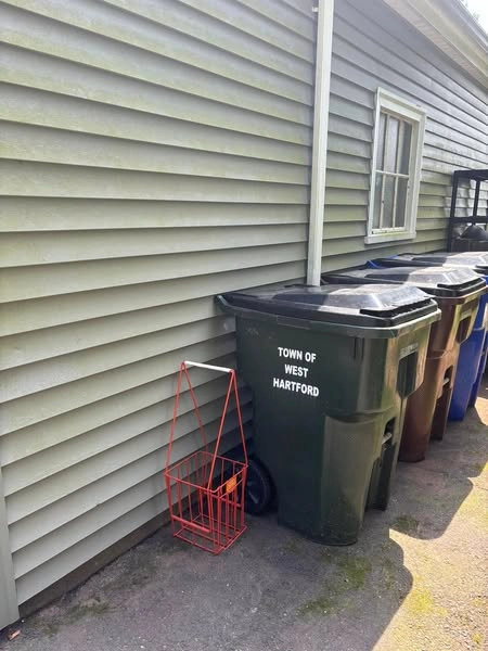 After photo: clean outdoor workspace with trash bin and tool cart after junk removal by Connecticut Heavy Hauling LLC
