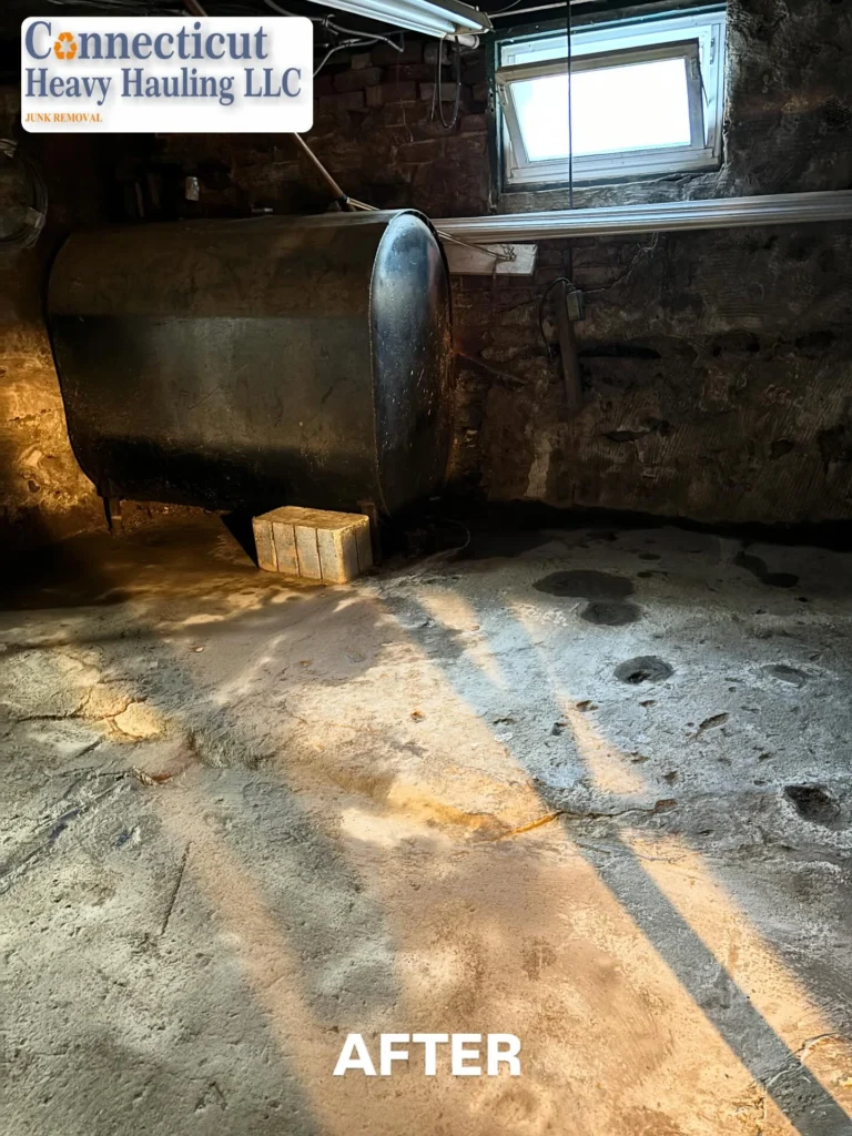 After photo: clean garage floor cleared of construction debris and tools by Connecticut Heavy Hauling LLC