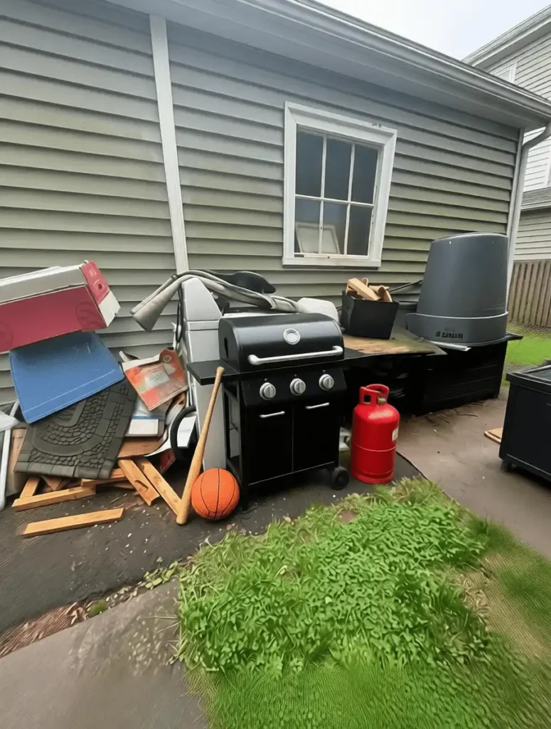 Furniture removal service: old sofa, bed, and refrigerator loaded on truck in Connecticut